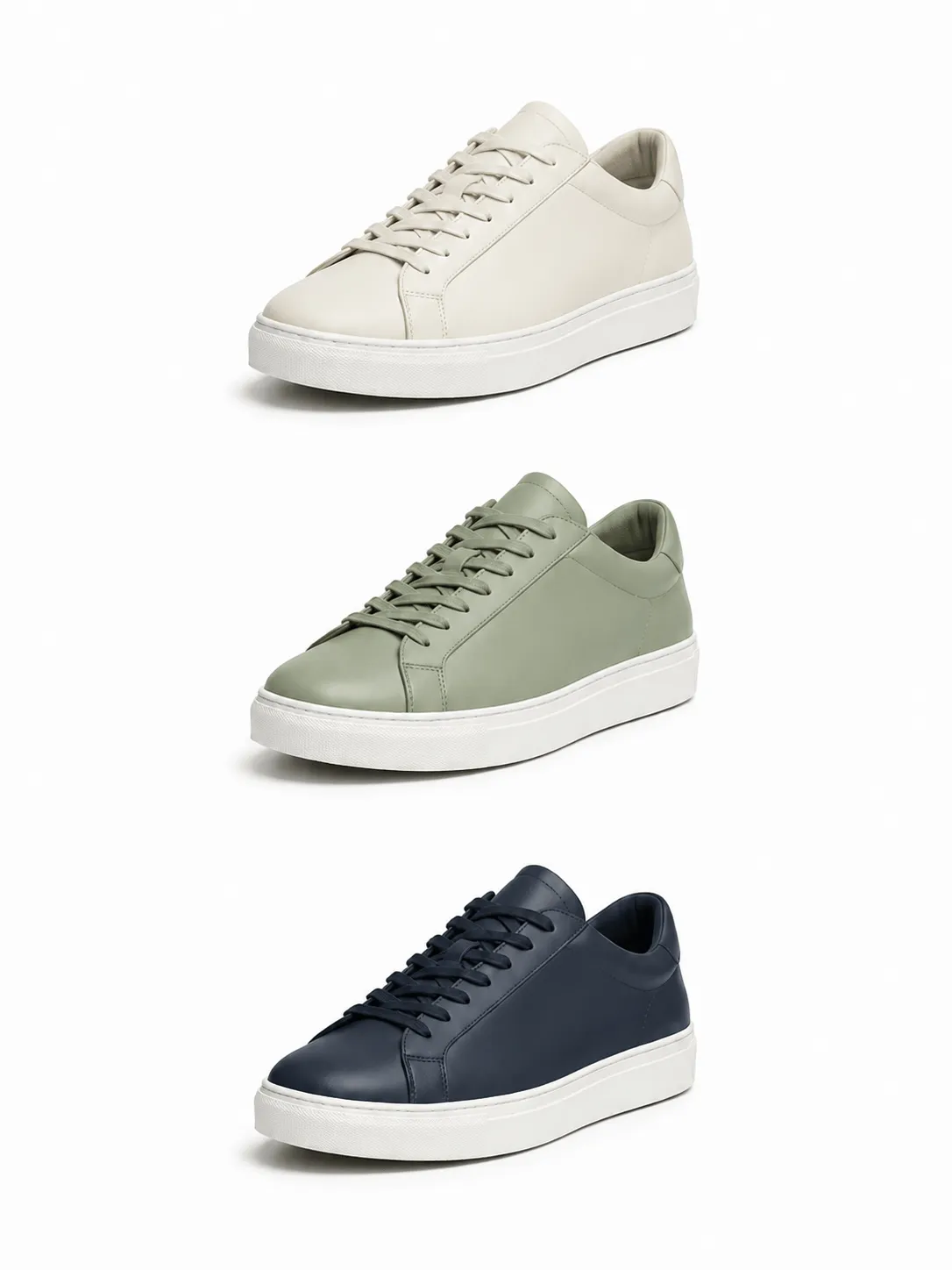 Three pairs of leather sneakers in cream, sage green, and navy blue stacked vertically against a white background.
